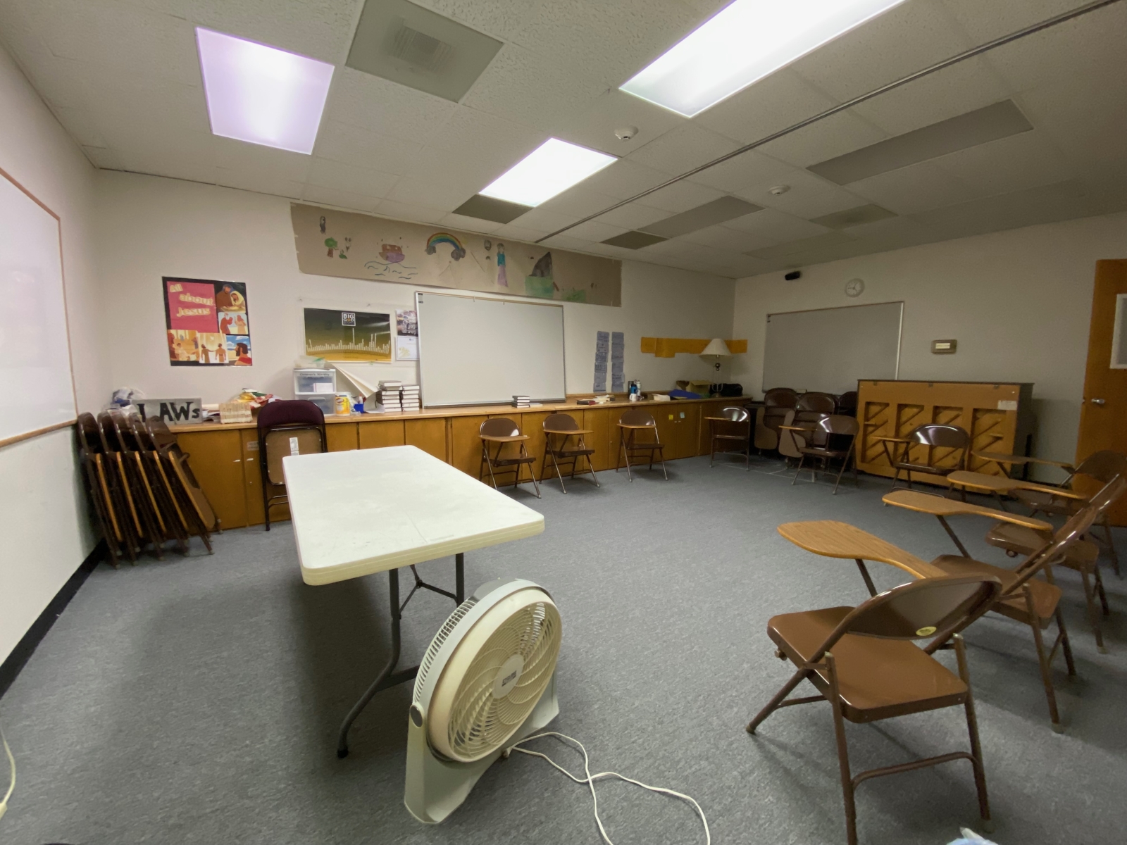 Room 217 has student desks, a piano, a table, a whiteboard, and a TV.