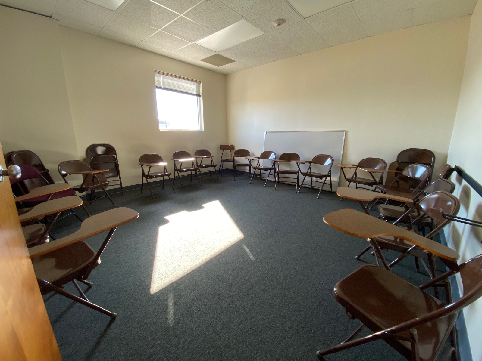 Room 218B has a whiteboard and some student desks.